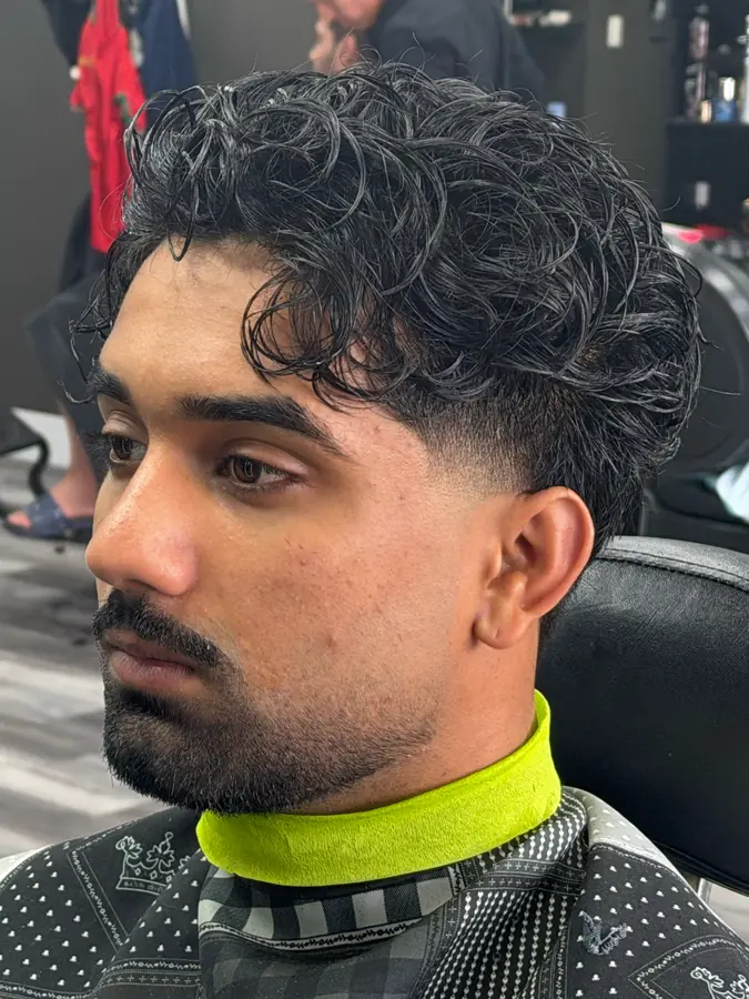 Textured curly top with a tapered side, finished at Fresh Cut Salon