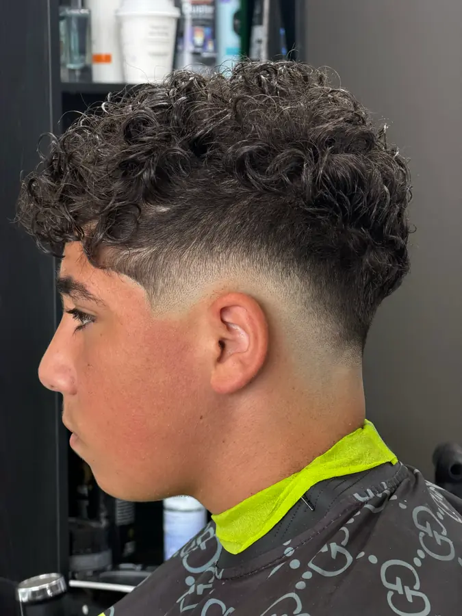 Curls left long over a high skin fade