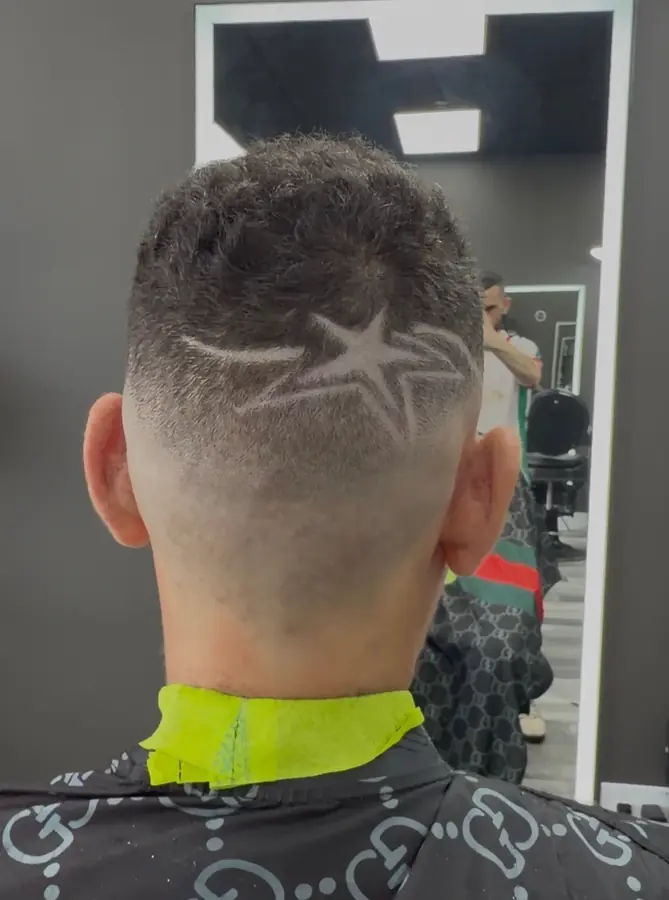A star shaved into a skin fade, seen from behind